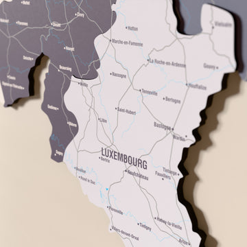Close-up of the Nimbus Belgium wooden wall map with layered regions and printed names