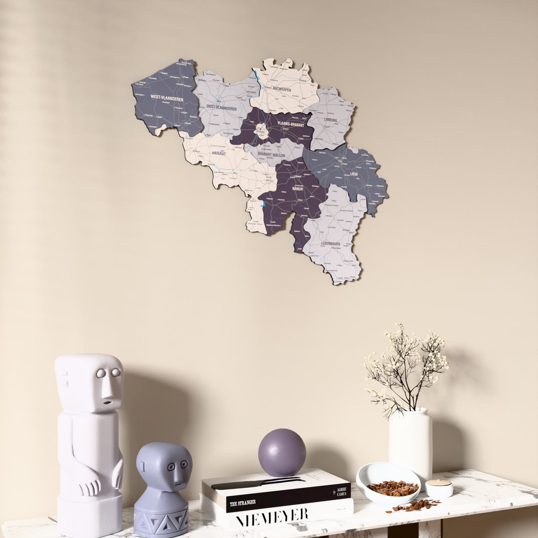 Nimbus Belgium wooden wall map on a beige wall above a console with figurines