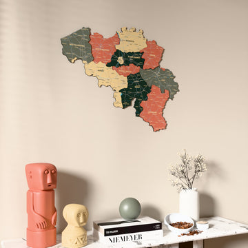 Sage Belgium wooden wall map on a beige wall above a console with figurines