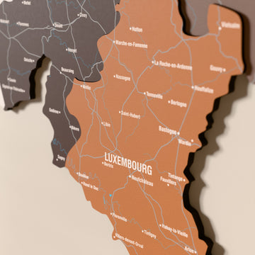 Close-up of the Soil Belgium wooden wall map with layered regions and printed names