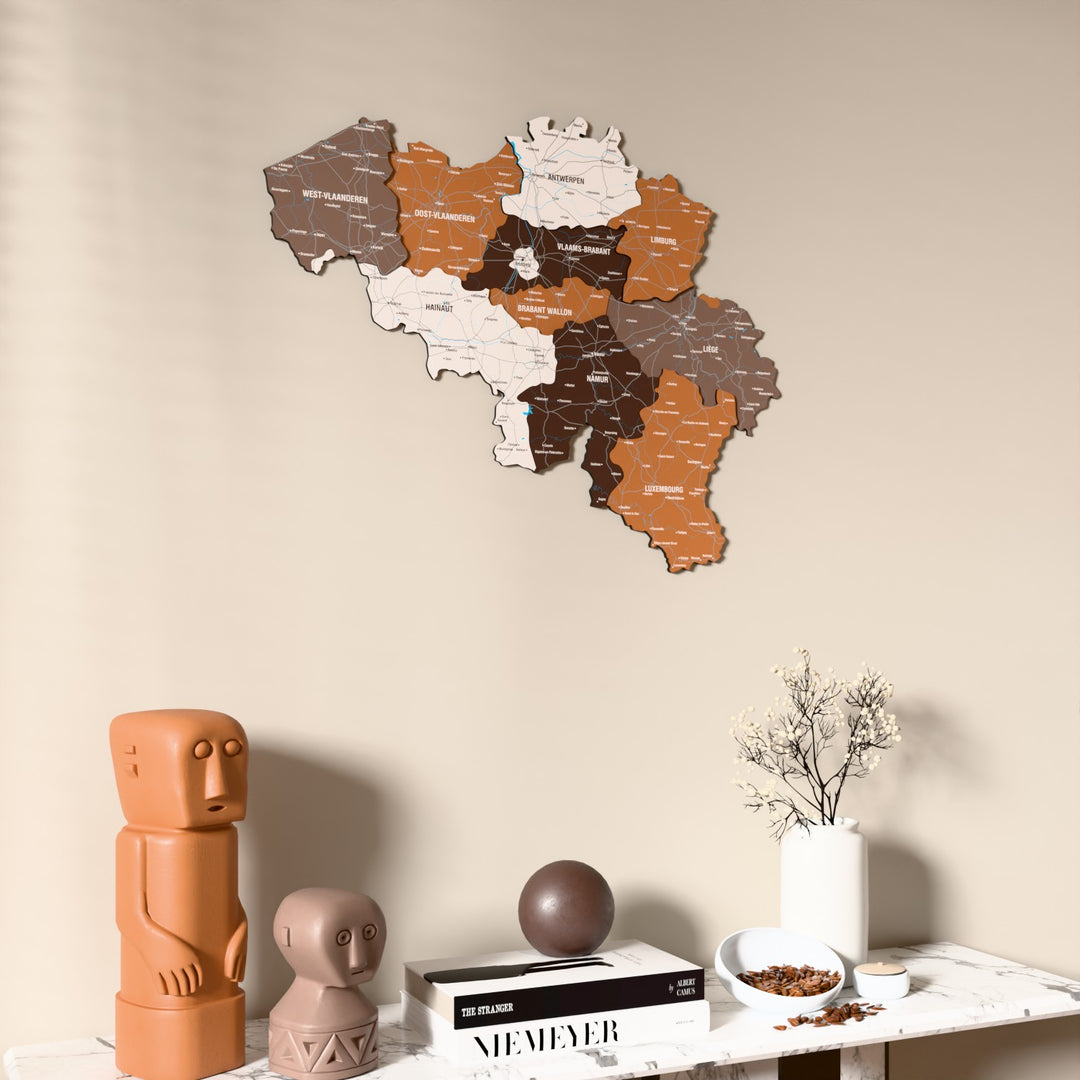 Soil Belgium wooden wall map on a beige wall above a console with figurines