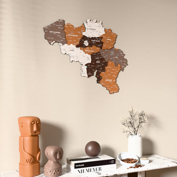 Soil Belgium wooden wall map on a beige wall above a console with figurines