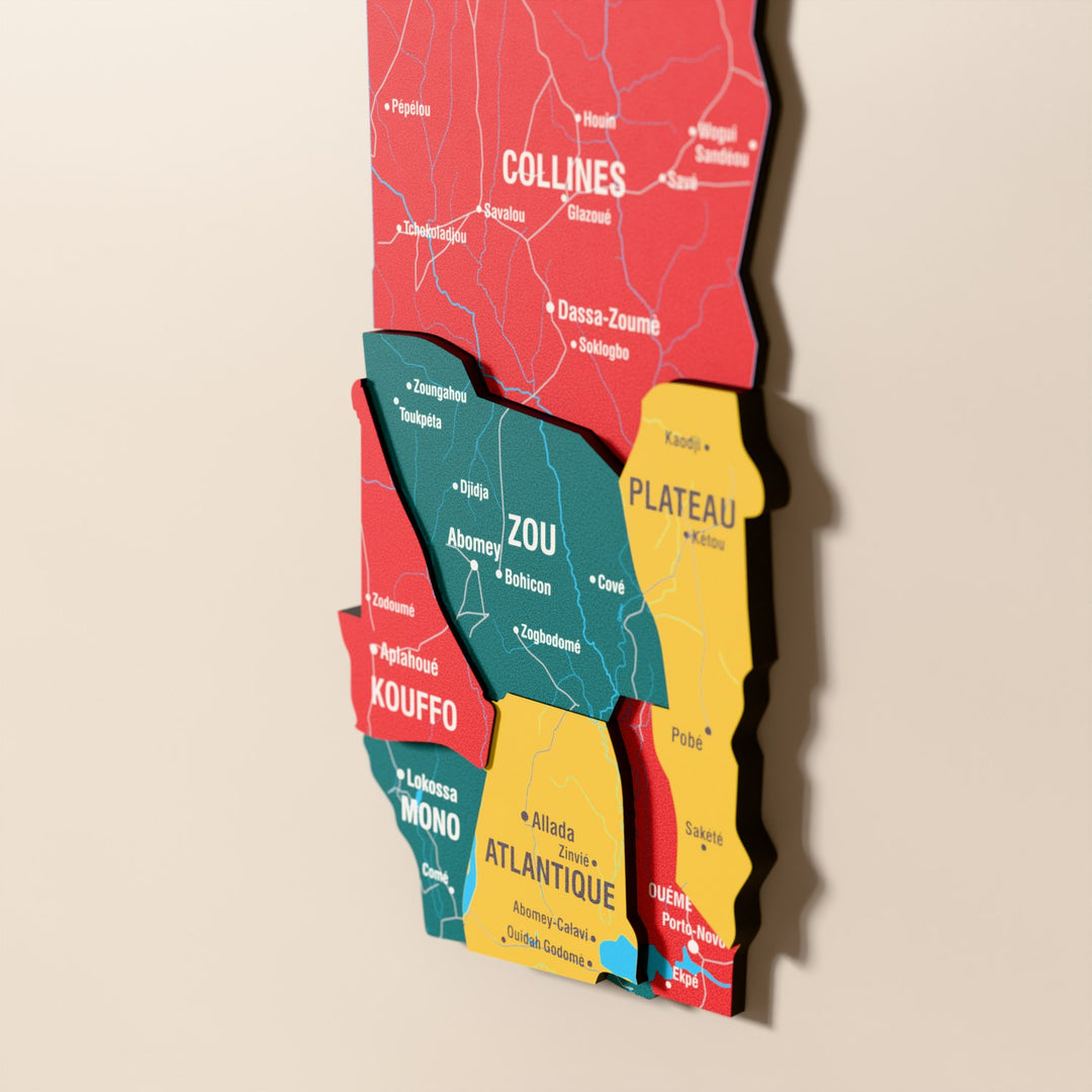 Close-up of the Flag colored Benin wooden wall map with layered regions and printed names