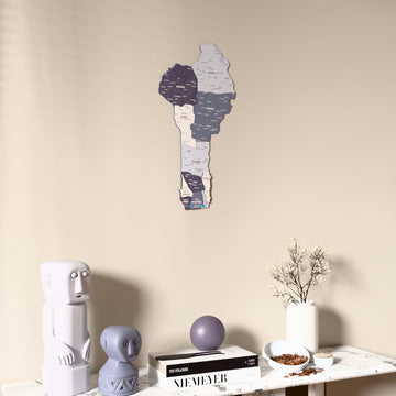 Nimbus Benin wooden wall map on a beige wall above a console with figurines