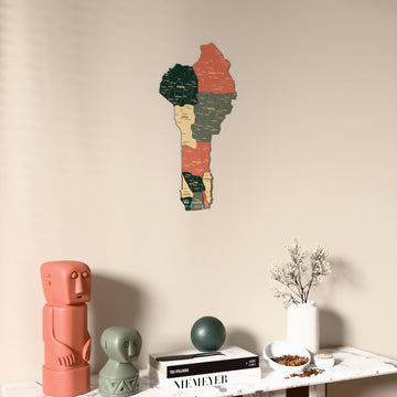 Sage Benin wooden wall map on a beige wall above a console with figurines
