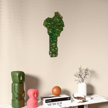 Satellite Benin wooden wall map on a beige wall above a console with figurines