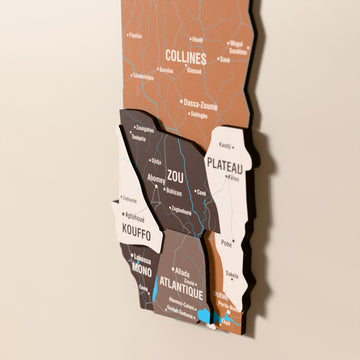 Close-up of the Soil Benin wooden wall map with layered regions and printed names