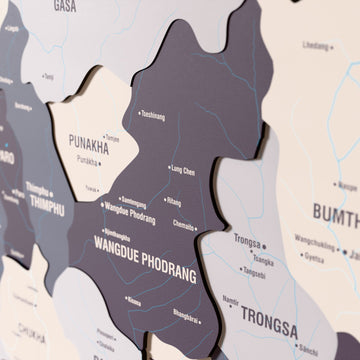 Close-up of the Nimbus Bhutan wooden wall map with layered regions and printed names