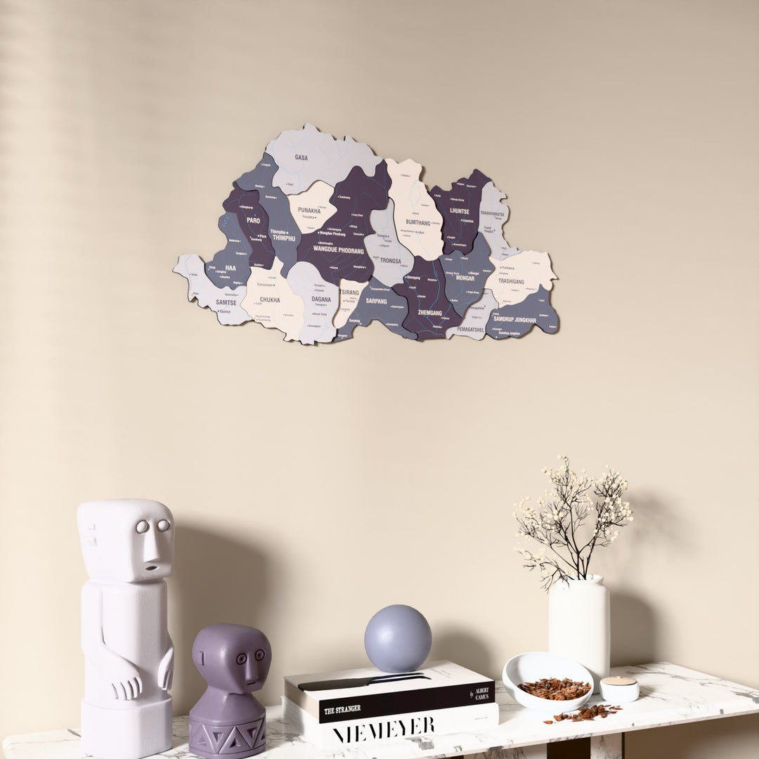 Nimbus Bhutan wooden wall map on a beige wall above a console with figurines