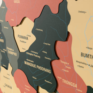 Close-up of the Sage Bhutan wooden wall map with layered regions and printed names