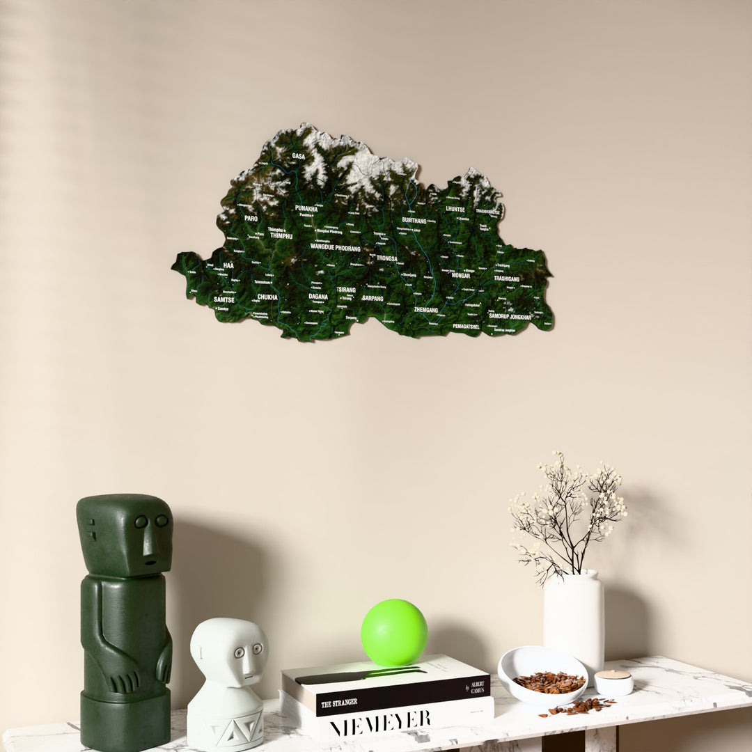 Satellite Bhutan wooden wall map on a beige wall above a console with figurines