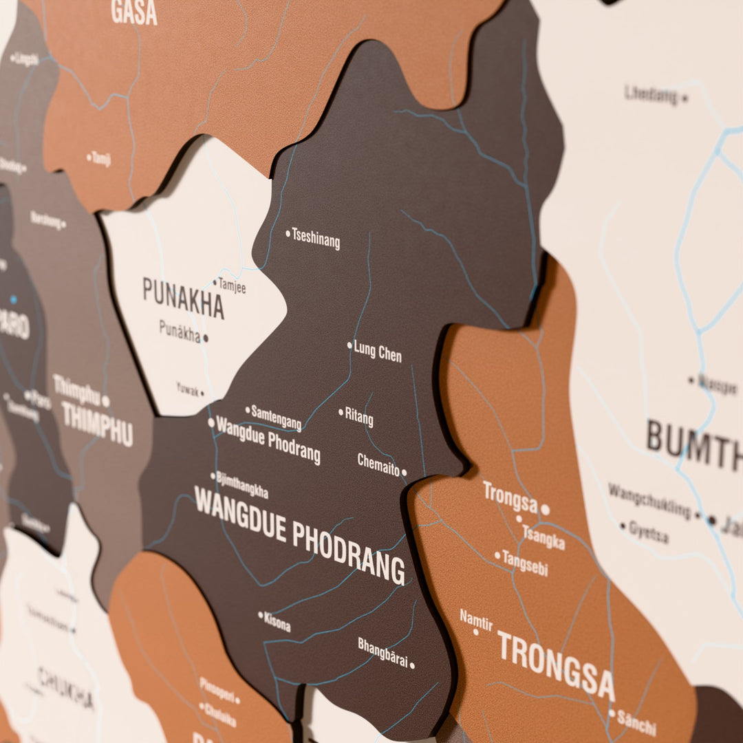 Close-up of the Soil Bhutan wooden wall map with layered regions and printed names