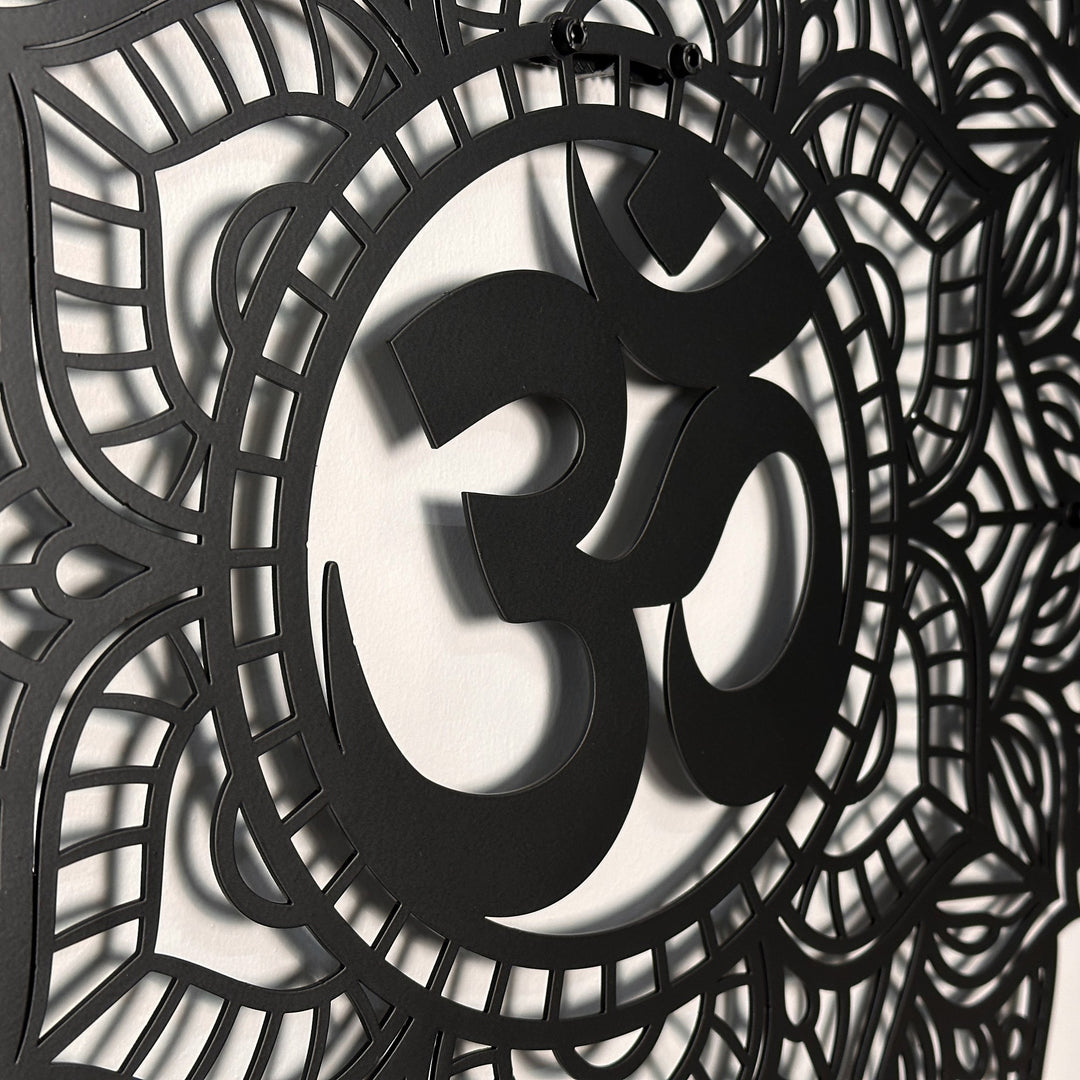 Close-up of the black OM mandala metal wall art showing the raised OM symbol and layered cutout petals