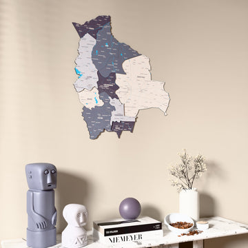 Nimbus Bolivia wooden wall map on a beige wall above a console with figurines
