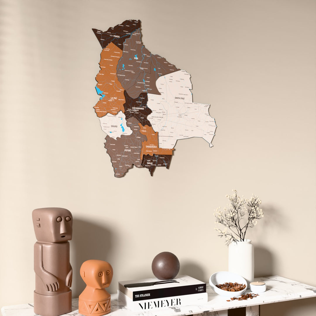 Soil Bolivia wooden wall map on a beige wall above a console with figurines