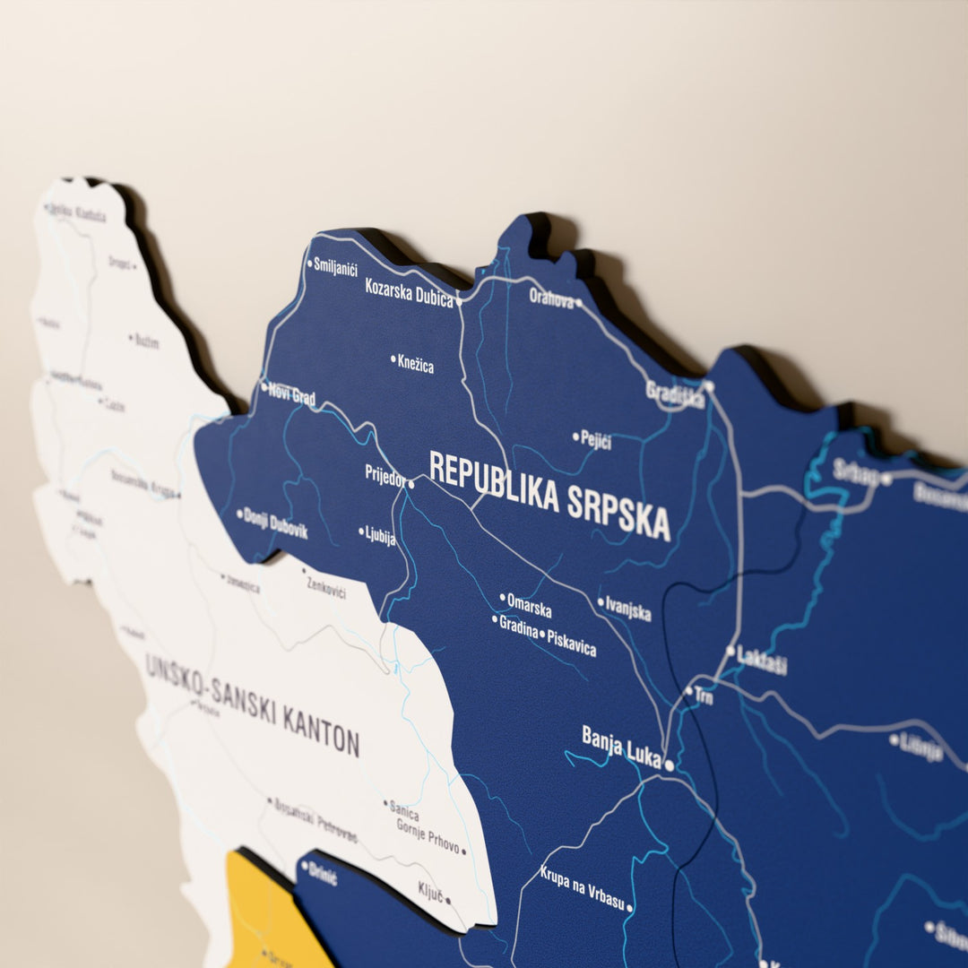 Close-up of the Flag colored Bosnia and Herzegovina wooden wall map with layered regions and printed names