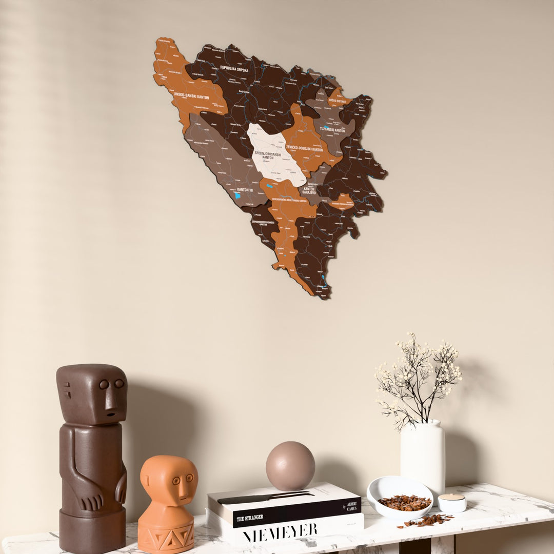Soil Bosnia and Herzegovina wooden wall map on a beige wall above a console with figurines