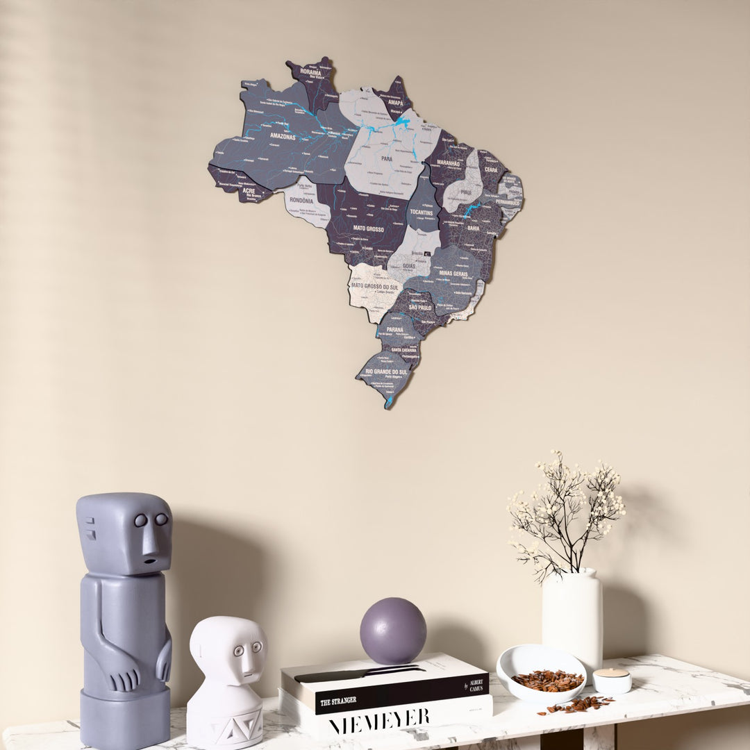 Nimbus Brazil wooden wall map on a beige wall above a console with figurines