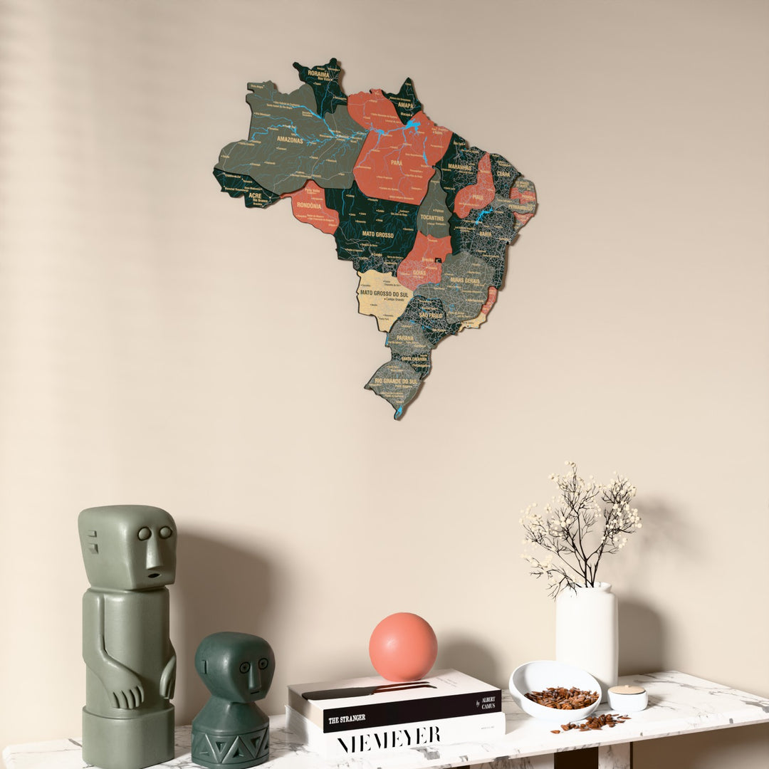 Sage Brazil wooden wall map on a beige wall above a console with figurines