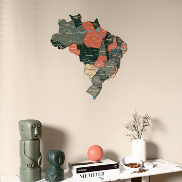 Sage Brazil wooden wall map on a beige wall above a console with figurines