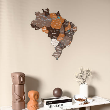 Soil Brazil wooden wall map on a beige wall above a console with figurines