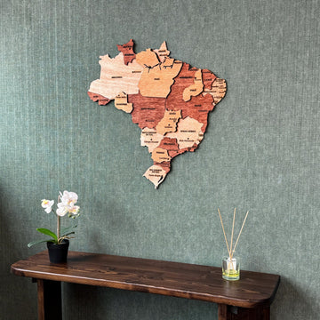 Wooden Brazil map on a green wall above a console table, closer angled shot