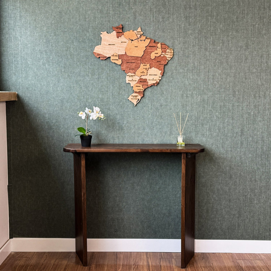 Brazil wood wall map above a console table, wide view with white baseboard