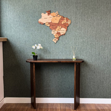 Brazil wood wall map above a console table, wide view with white baseboard