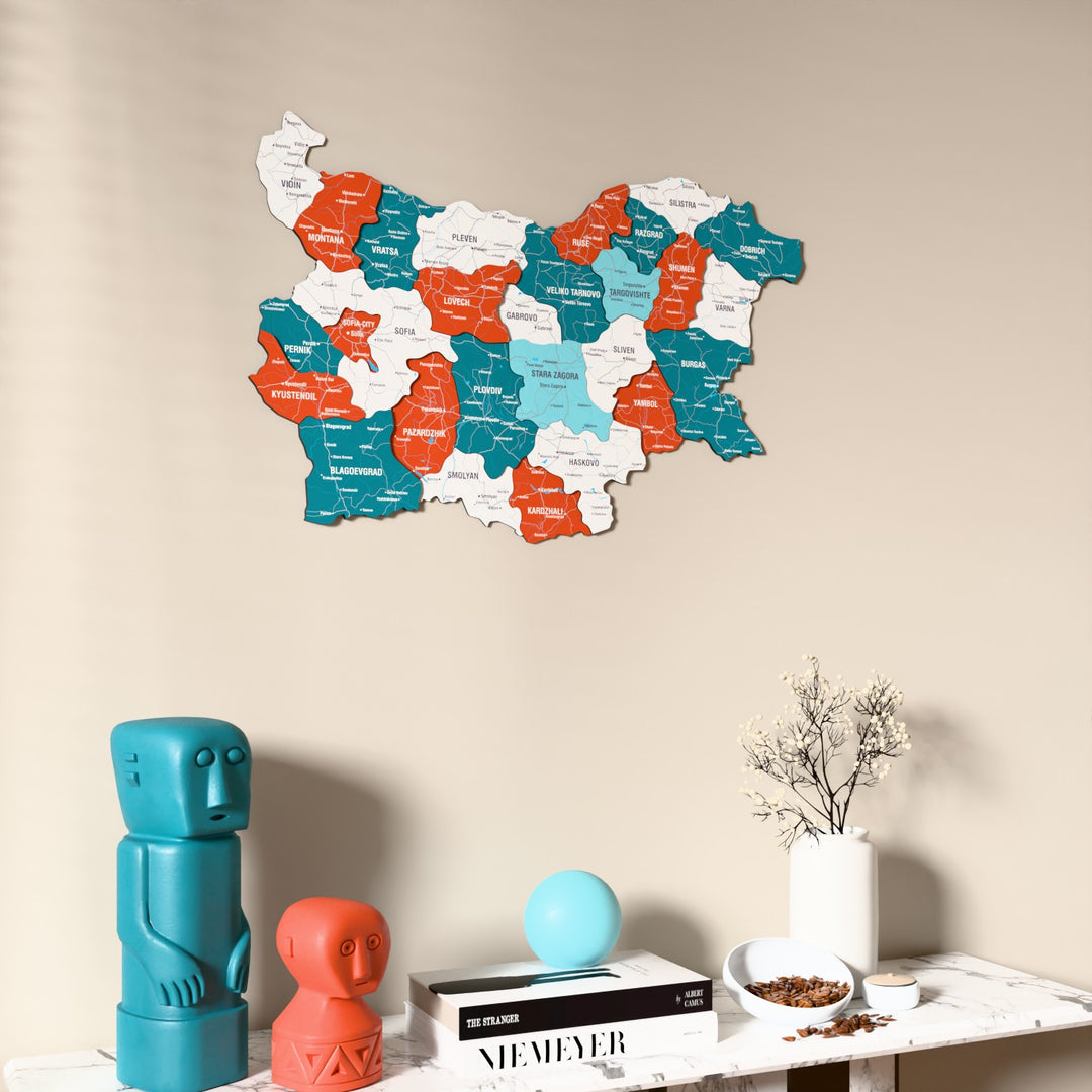 Flag colored Bulgaria wooden wall map on a beige wall above a console with figurines