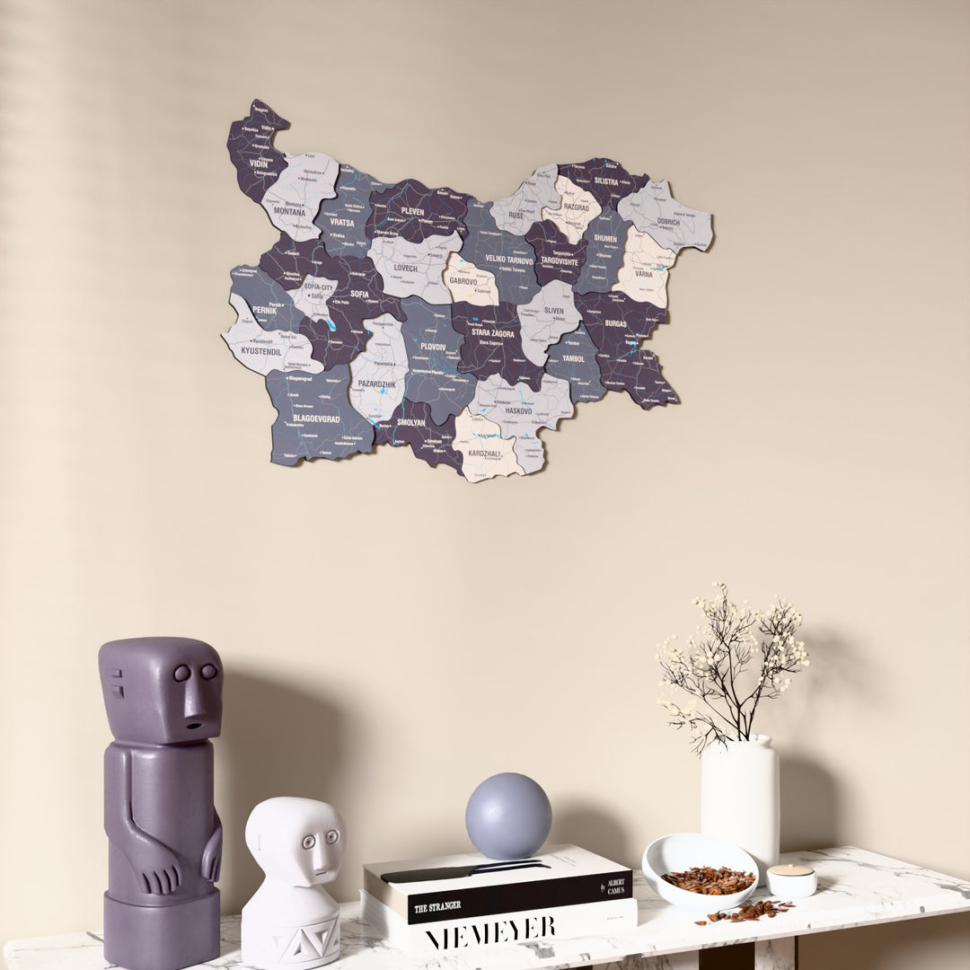 Nimbus Bulgaria wooden wall map on a beige wall above a console with figurines