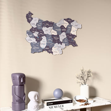 Nimbus Bulgaria wooden wall map on a beige wall above a console with figurines