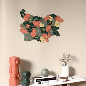 Sage Bulgaria wooden wall map on a beige wall above a console with figurines