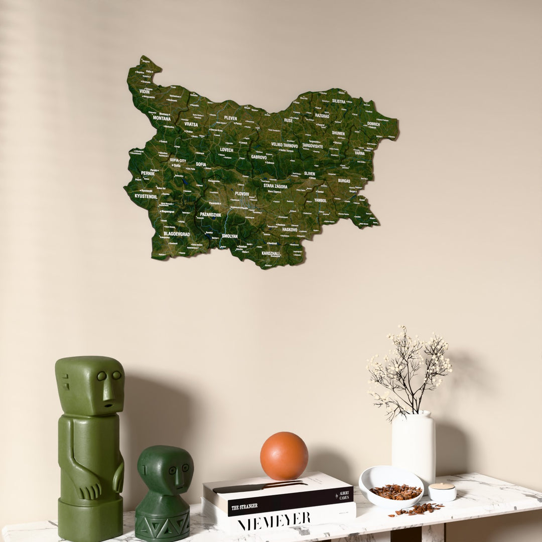 Satellite Bulgaria wooden wall map on a beige wall above a console with figurines