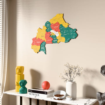 Flag colored Burkina Faso wooden wall map beside a sheer curtain, angled view