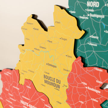 Close-up of the Flag colored Burkina Faso wooden wall map with layered regions and printed names