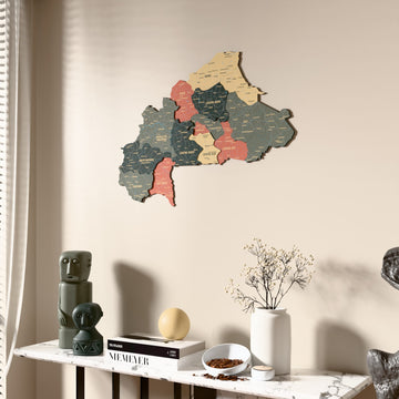 Sage Burkina Faso wooden wall map beside a sheer curtain, angled view