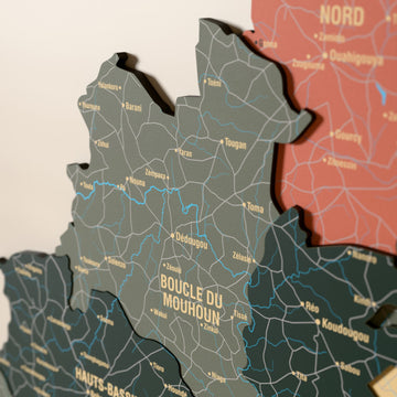 Close-up of the Sage Burkina Faso wooden wall map with layered regions and printed names