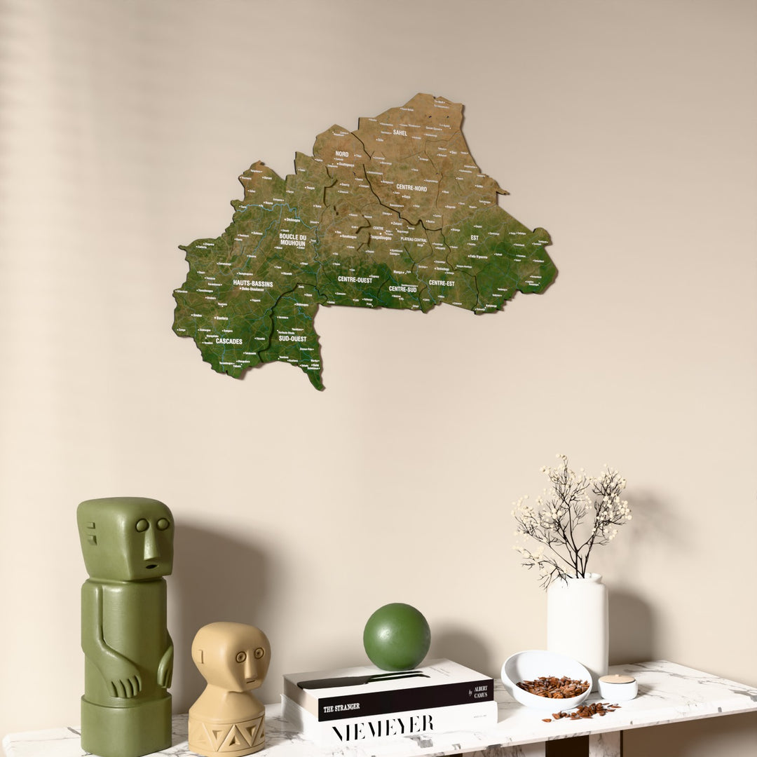 Satellite Burkina Faso wooden wall map on a beige wall above a console with figurines