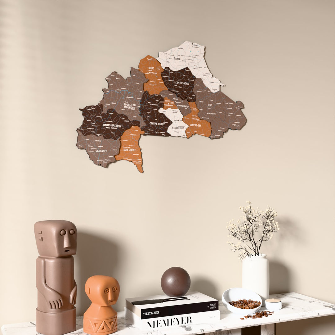 Soil Burkina Faso wooden wall map on a beige wall above a console with figurines