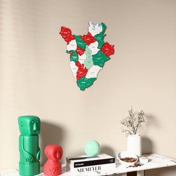 Flag colored Burundi wooden wall map on a beige wall above a console with figurines