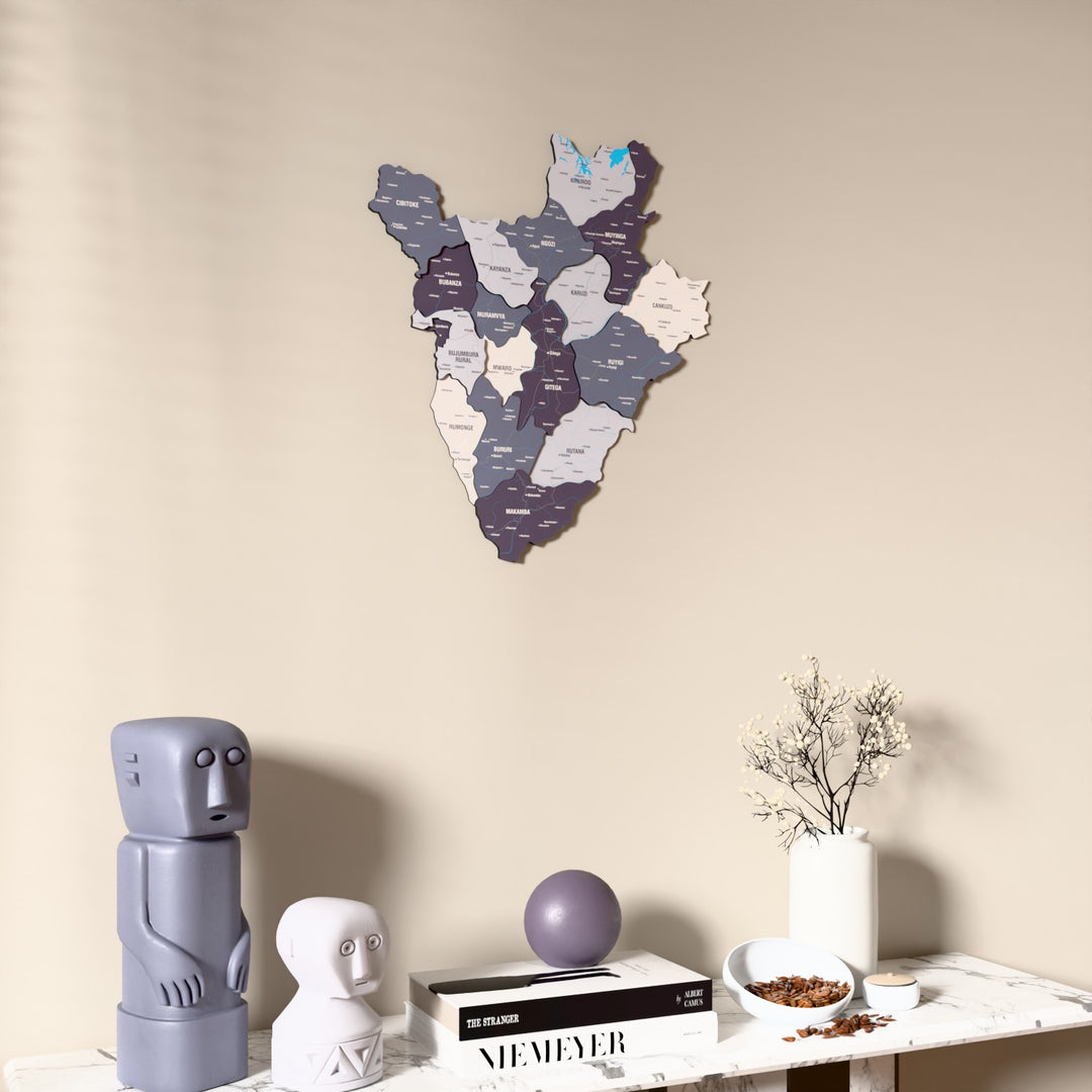 Nimbus Burundi wooden wall map on a beige wall above a console with figurines