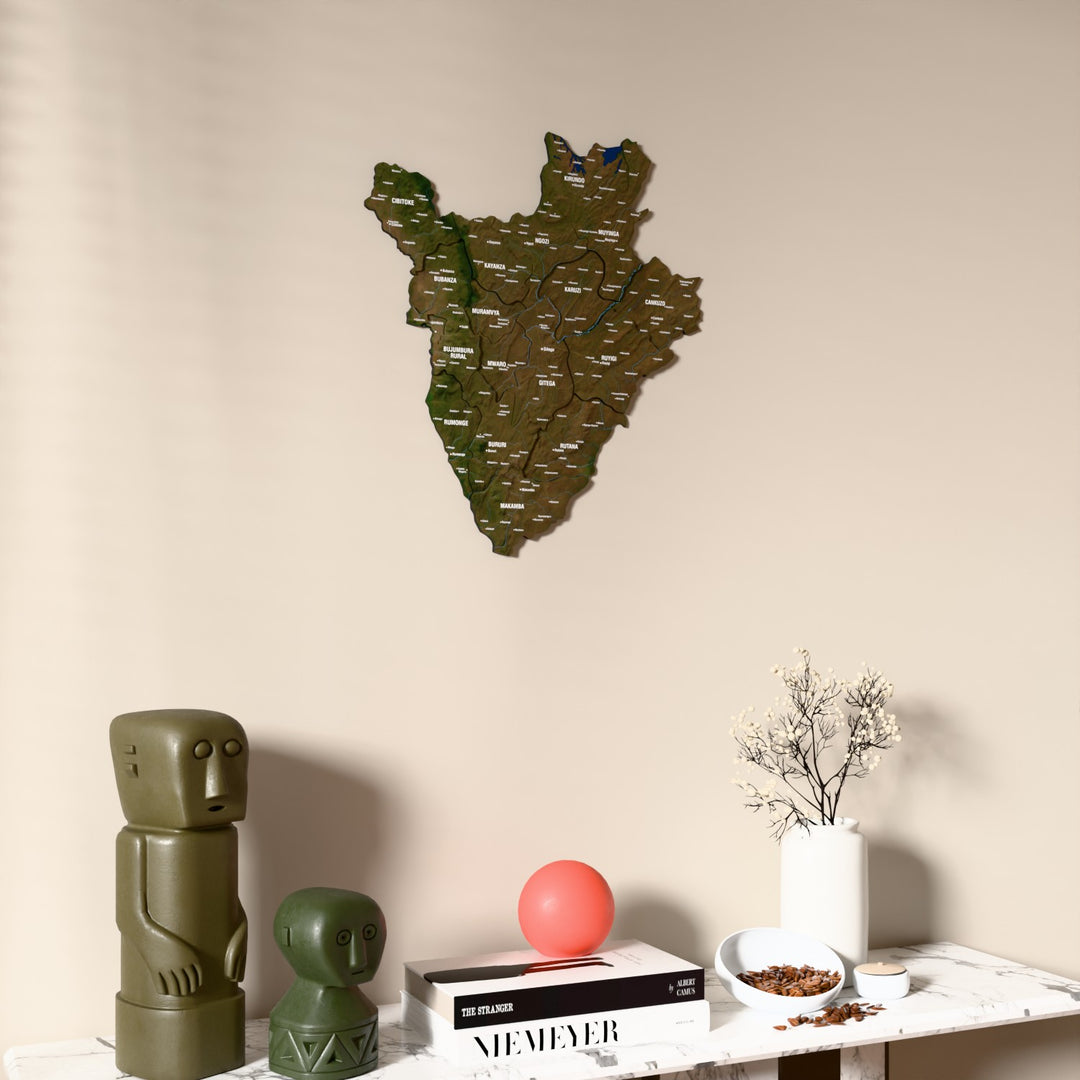 Satellite Burundi wooden wall map on a beige wall above a console with figurines