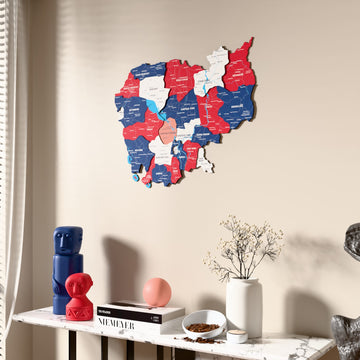 Flag colored Cambodia wooden wall map beside a sheer curtain, angled view