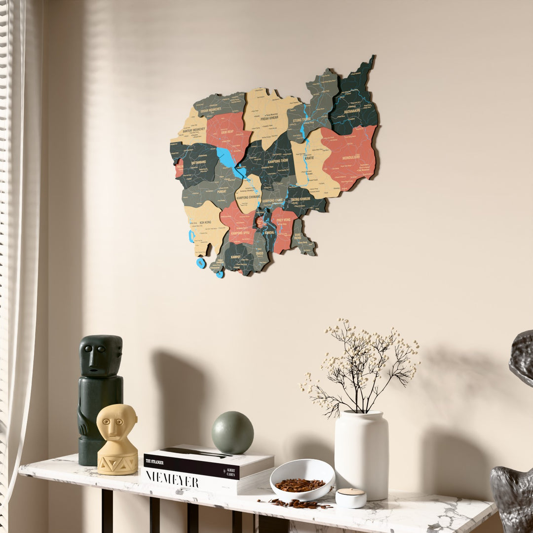 Sage Cambodia wooden wall map beside a sheer curtain, angled view