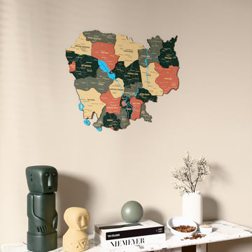 Sage Cambodia wooden wall map on a beige wall above a console with figurines