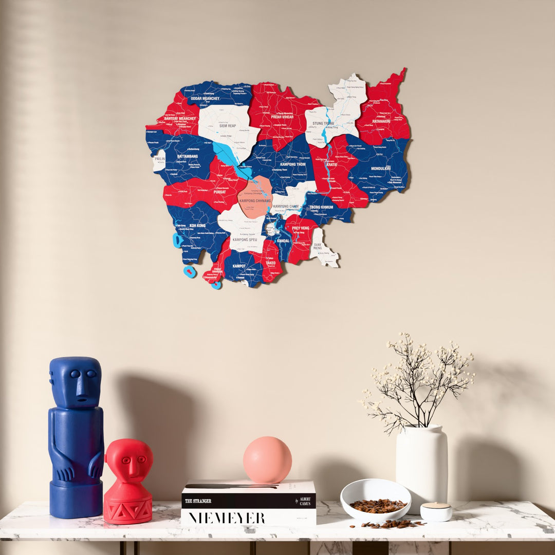 Flag colored Cambodia wooden wall map above a marble console, front view