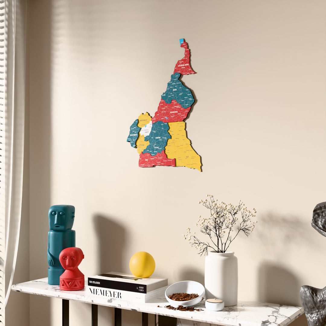 Flag colored Cameroon wooden wall map beside a sheer curtain, angled view