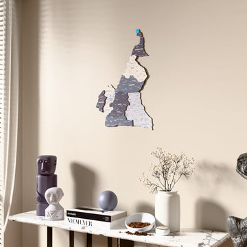 Nimbus Cameroon wooden wall map beside a sheer curtain, angled view