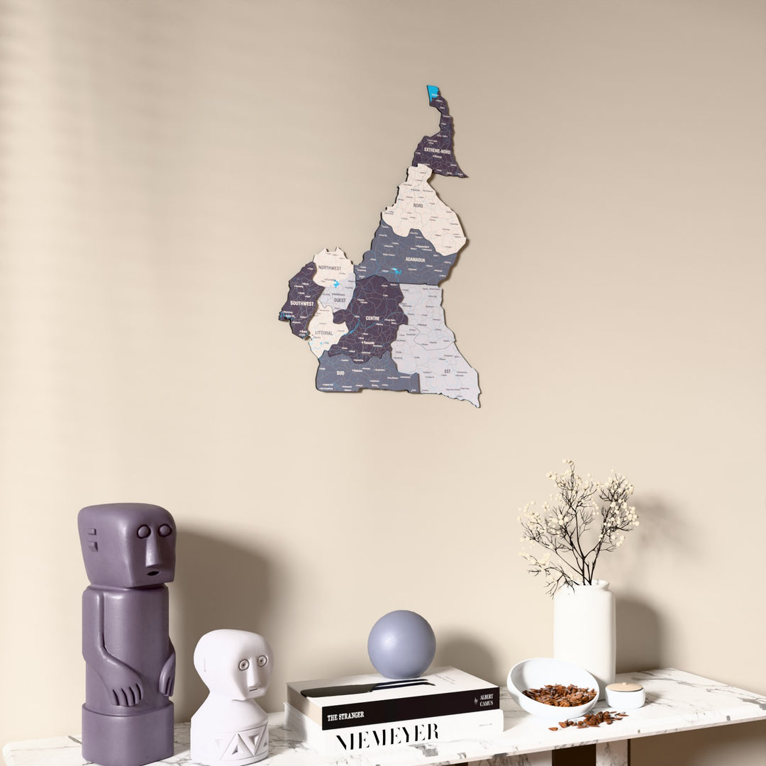 Nimbus Cameroon wooden wall map on a beige wall above a console with figurines