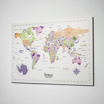 Watercolor world map canvas on a white wall, angled side view showing the canvas edge